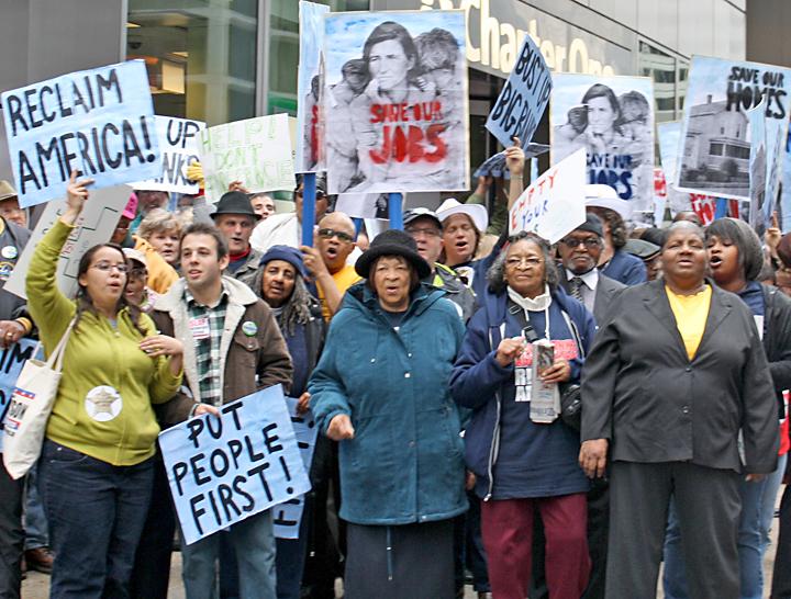 Protesters march for a just economy that puts jobs, homes and people before profits