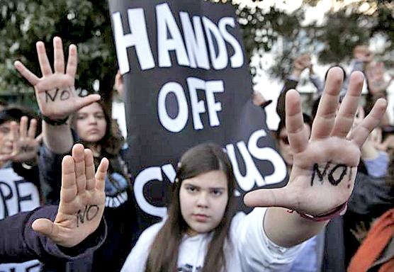 Protesters in Cyprus gather outside parliament to protest the deal with the troika