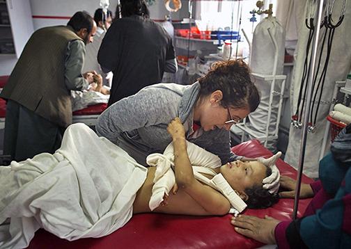 Doctors care for the victim in the bombed U.S. hospital in Kunduz