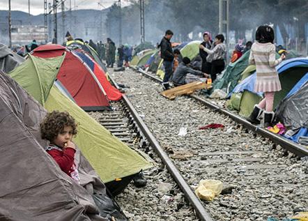 Refugee families stranded in a camp in Greece