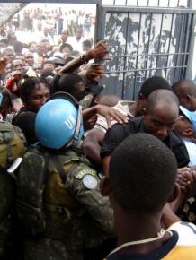 MINUSTAH troops move in on a crowd of voters during Haiti's 2006 elections