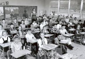 A teacher with her students in their classroom in 1958