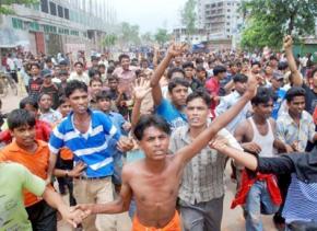 Striking garment workers who gathered to protest low wages flee police firing tear gas and rubber bullets