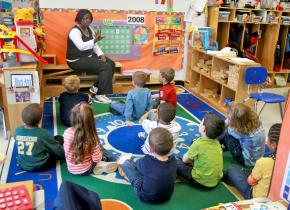 A first grade teacher talking to her class