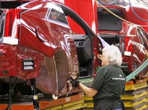 Working on an assembly line inside a GM plant