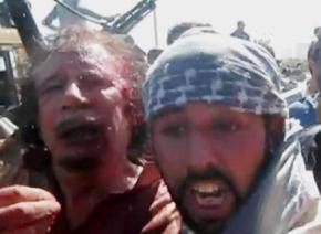 Video footage posted on the Internet showed an injured Qaddafi (left) in the custody of rebels