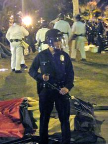 An LAPD officer guards the entrance to City Hall Park while police move against Occupy LA's camp