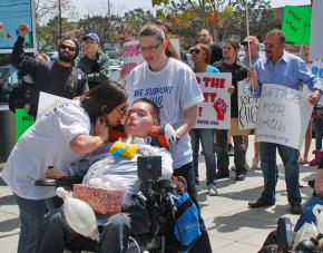Raul Carranza joins fellow protesters at an April rally against the cuts