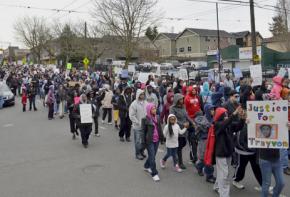 Protesters march in Seattle to mark one month since the murder of Trayvon Martin