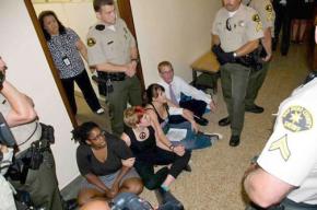 Four of the Equality 9 block a doorway during their 2010 sit-in
