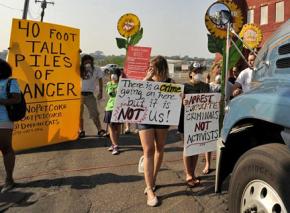 Activists block a truck carrying petroleum coke as it arrives at the Detroit waterfront