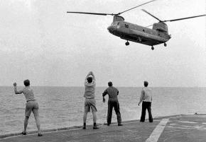 A U.S. military helicopter fleeing Saigon lands on an aircraft carrier