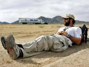 Rory Fanning resting next to a highway during his Walk for Pat