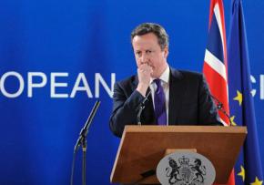 British Prime Minister David Cameron speaks to reporters during a European Council meeting